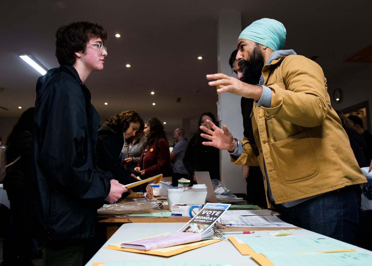 NDP Leader Jagmeet Singh, right, speaks with people at his campaign office during a campaign stop in Burnaby, B.C., on Monday, Oct. 21, 2019. (THE CANADIAN PRESS/Nathan Denette)