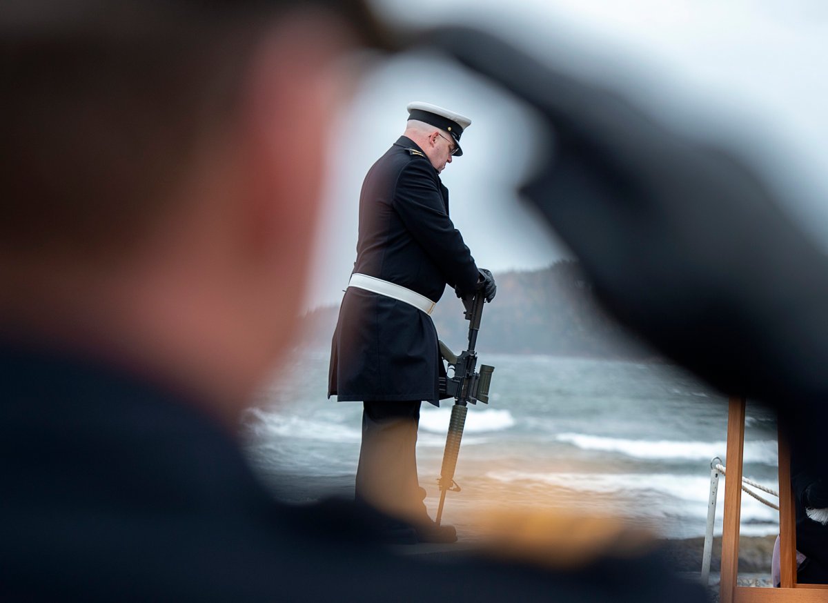A guard is framed by a saluting officer at the 50th anniversary of the fire and explosion in HMCS Kootenay at the Bonaventure Anchor Memorial in Point Pleasant Park in Halifax on Wednesday, Oct. 23, 2019. 