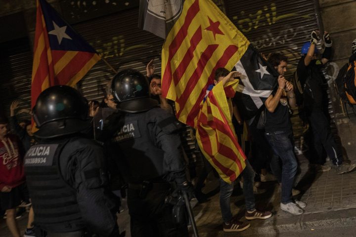 Police moves away protesters during clashes in Barcelona, Saturday, Oct. 26, 2019. The clash comes after 350,000 people protested peacefully Saturday against the imprisonment of nine Catalan separatist leaders for their roles in an illegal 2017 secession bid.