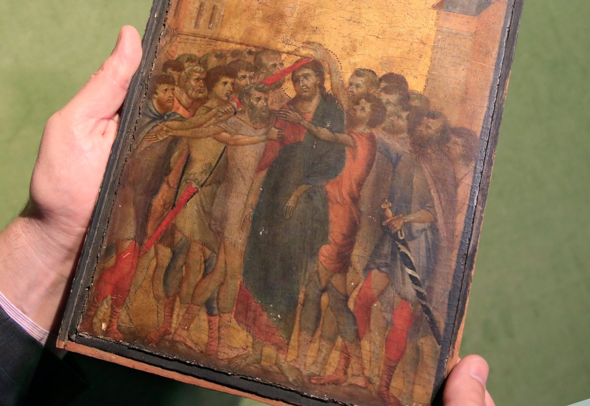 In this Tuesday, Sept. 24, 2019 file photo, art expert Stephane Pinta points to a 13th-century painting by Italian master Cimabue in Paris, Tuesday, Sept. 24, 2019. 