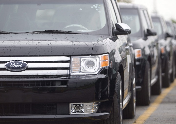 Ford Flex crossover vehicles sit in parking lots outside the production facility in Oakville, Ont., Tuesday, June 3, 2008. Ford Motor Co.'s largest Canadian manufacturing operation will eliminate 450 jobs by early 2020 as the company discontinues two of the models made at the Oakville, Ont., complex. 