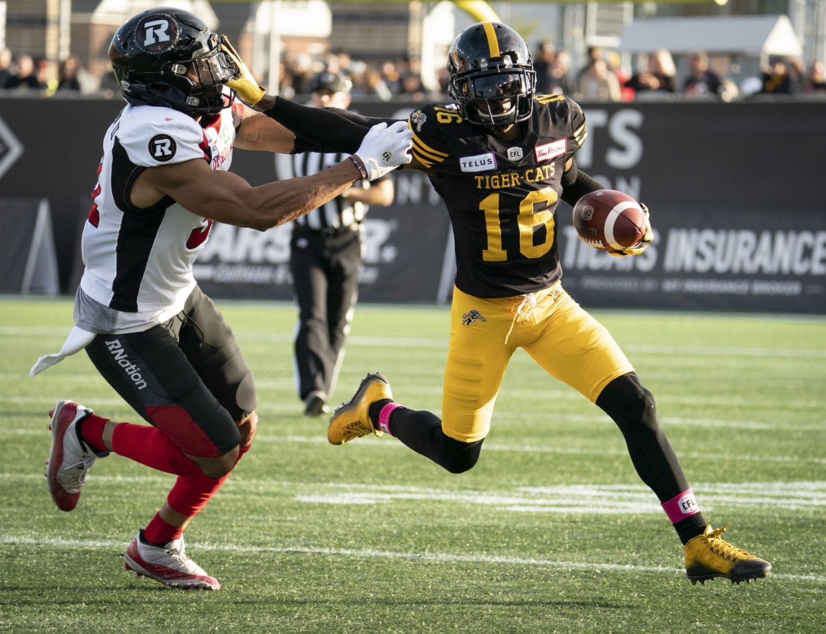 Hamilton Tiger-Cats wide receiver Brandon Banks (16) fends off Ottawa Redblacks linebacker Kevin Brown II (31) during CFL football action in Hamilton, Ont.. on Saturday, Oct. 19, 2019. 