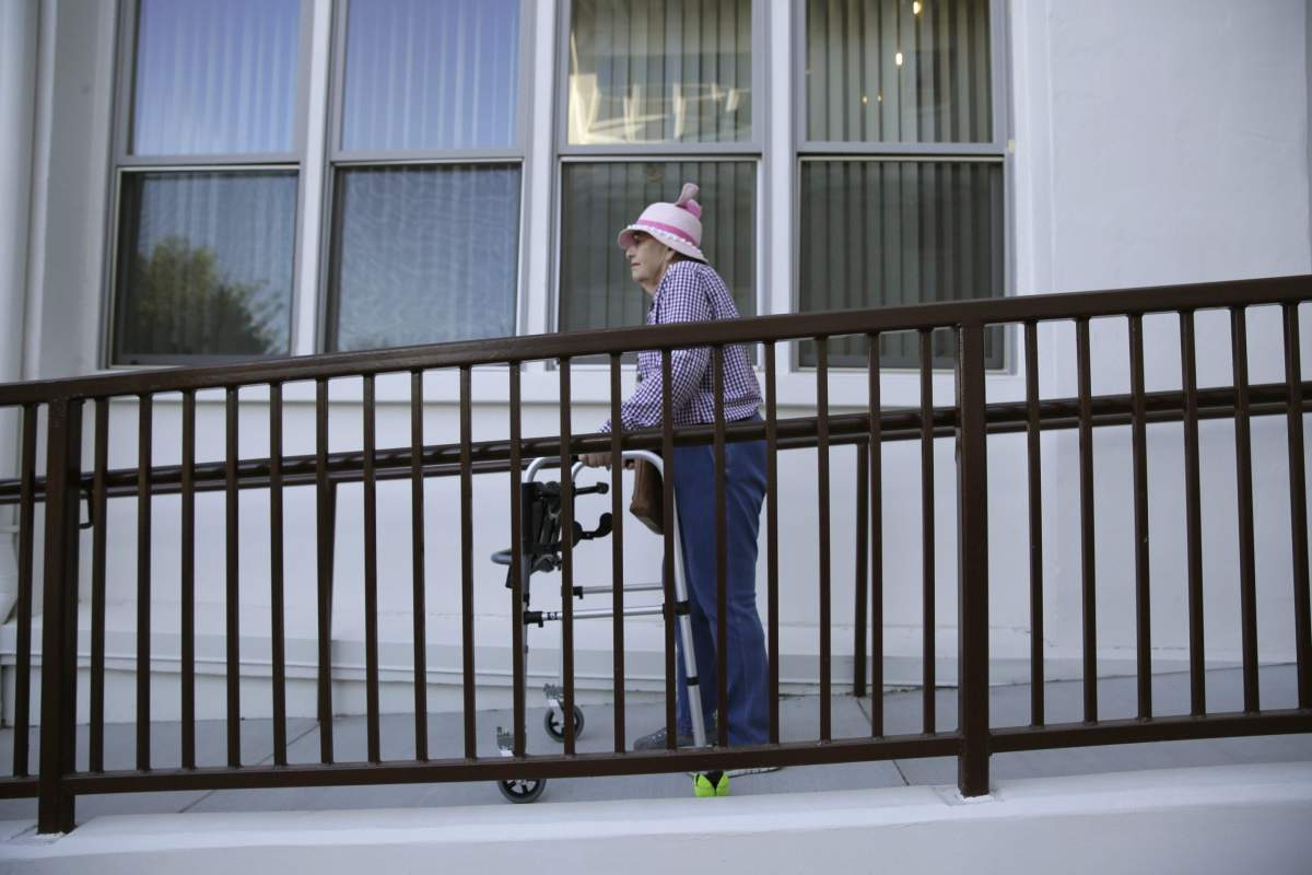 Patty Zahnow, 77, makes her way down a ramp at the Villas at Hamilton housing complex for low income seniors Wednesday, Oct. 30, 2019, in Novato, Calif.