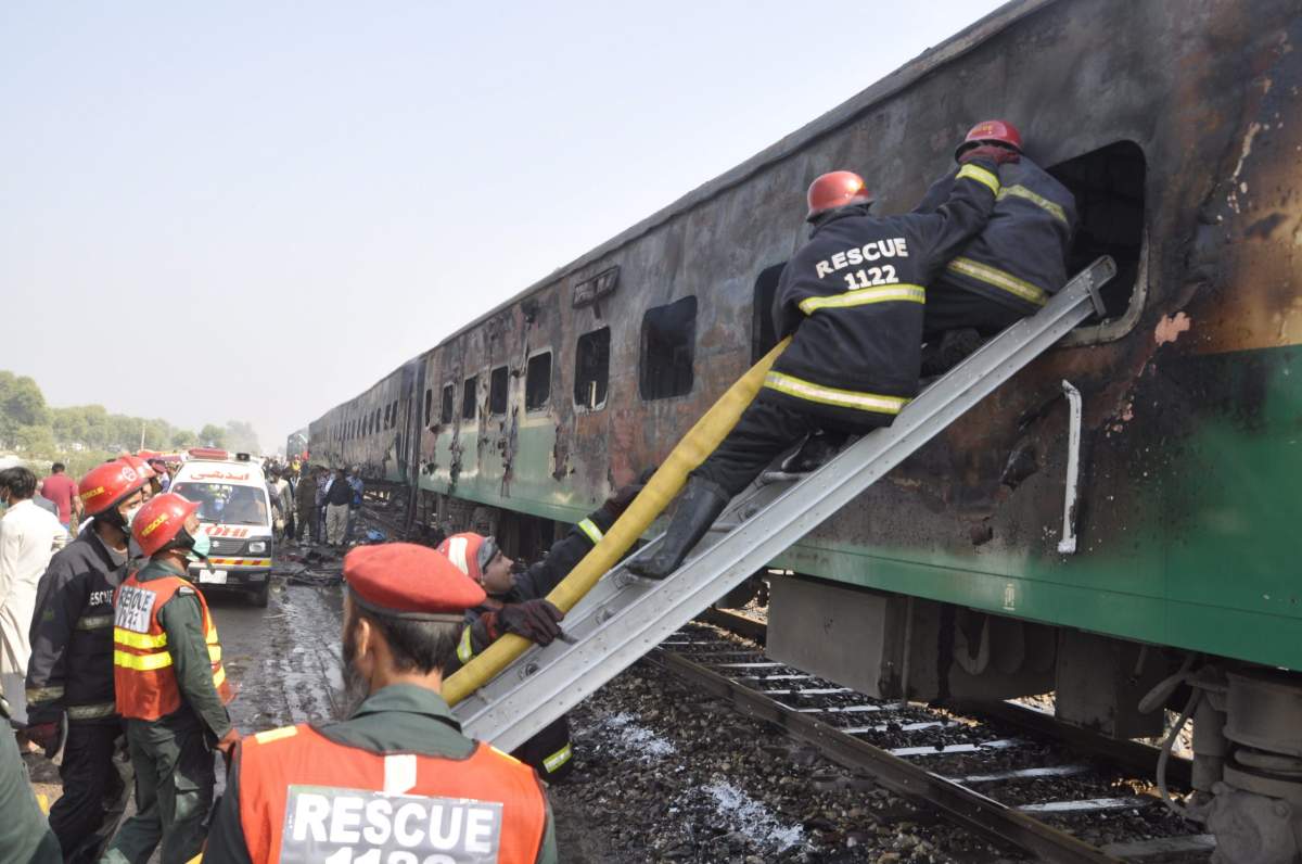 Rescue workers look for survivors following a train damaged by a fire in Liaquatpur, Pakistan, Thursday, Oct. 31, 2019. A massive fire engulfed three carriages of the train traveling in the country’s eastern Punjab province (AP Photo/Siddique Baluch)