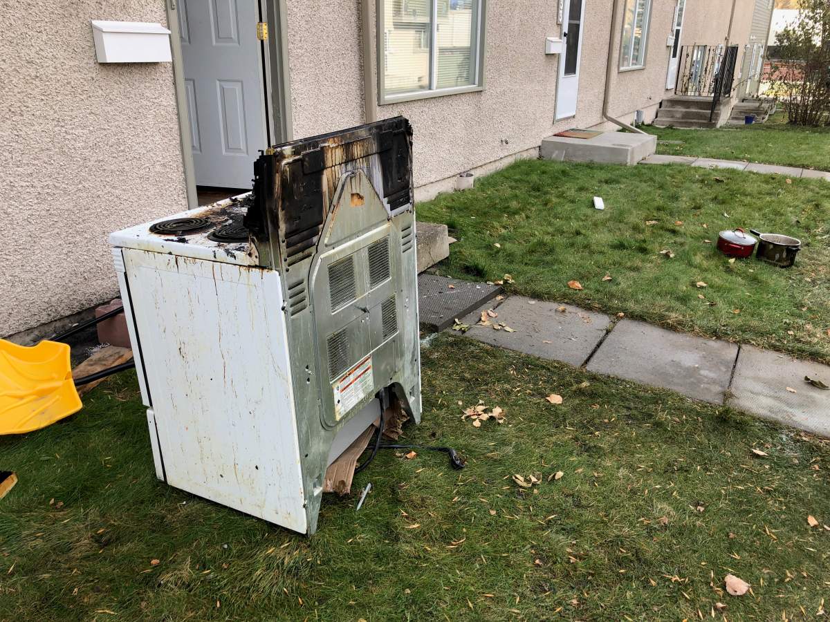 Charred oven seen outside a townhouse that saw damage from a fire on Tuesday, Oct. 15.