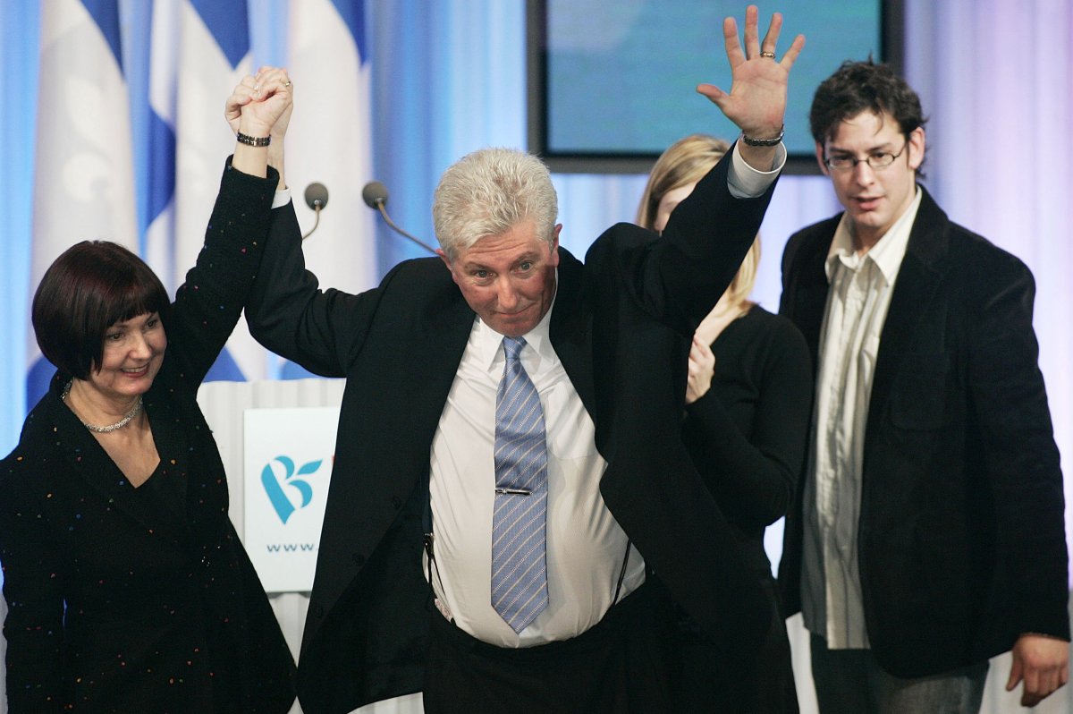 In 2006, former Bloc Québécois Leader Gilles Duceppe joins hands with his wife Yolande Brunelle at the end of his election speech. Duceppe's son Alexis and daughter Amelie stand behind. 