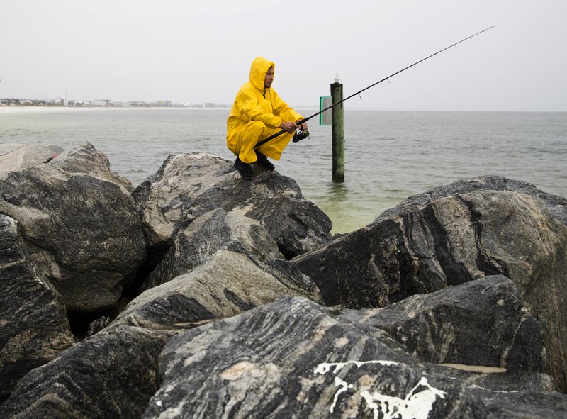 Michael Foster fishes as Tropical Storm Nestor approaches, Friday, Oct. 18, 2019 in Mexico Beach, Fla.. Forecasters say a disturbance moving through the Gulf of Mexico has become Tropical Storm Nestor. The National Hurricane Center says high winds and dangerous storm surge are likely along parts of the northern Gulf Coast. Conditions are expected to deteriorate Friday into early Saturday. 