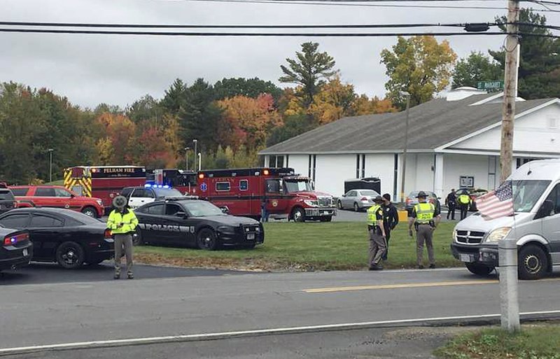 In this photo provided by WMUR-TV, police stand outside the New England Pentecostal Church on Saturday, Oct. 12, 2019, in Pelham, N.H. 