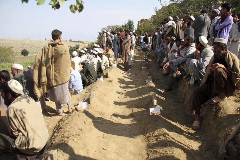 Afghan men bury victims of Friday's deadly bomb blast in the mosque in the village of Jodari at Haskamena district of Jalalabad east of Kabul, Afghanistan, Saturday, Oct. 19, 2019. Funerals are being held in eastern Afghanistan for the victims of Friday's deadly bomb blast in a village mosque which killed 62 people during prayers. 