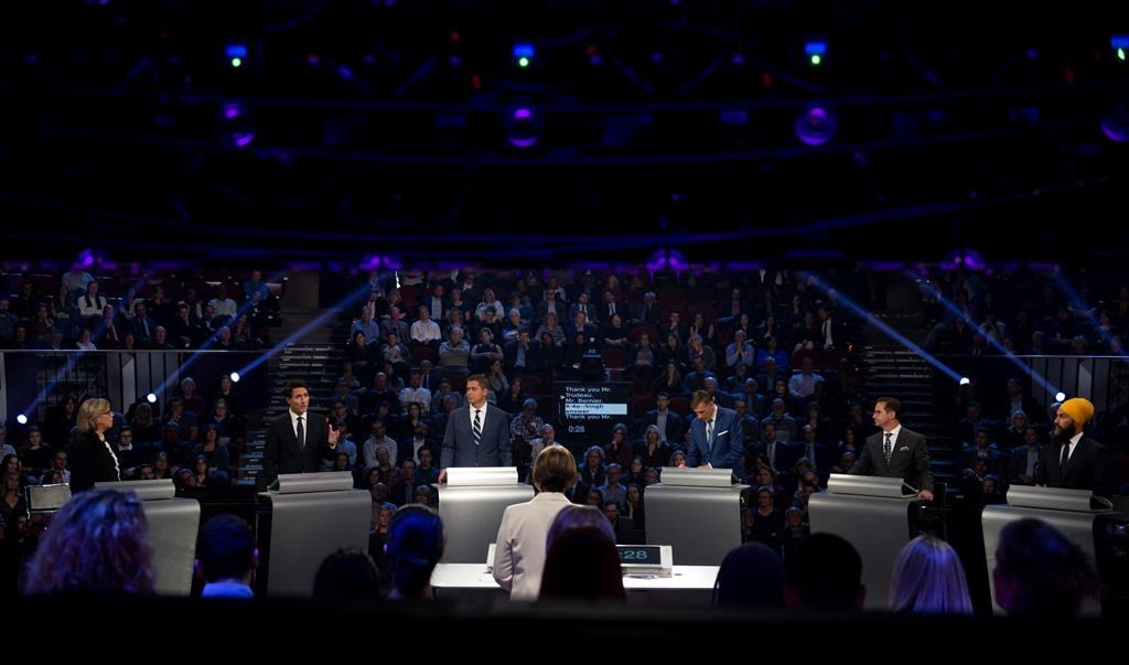Liberal leader Justin Trudeau, second left, speaks as Green Party leader Elizabeth May, left to right, Conservative leader Andrew Scheer, People's Party of Canada leader Maxime Bernier, Bloc Quebecois leader Yves-Francois Blanchet and NDP leader Jagmeet Singh look on during the Federal leaders debate in Gatineau, Que. Monday, October 7, 2019.
