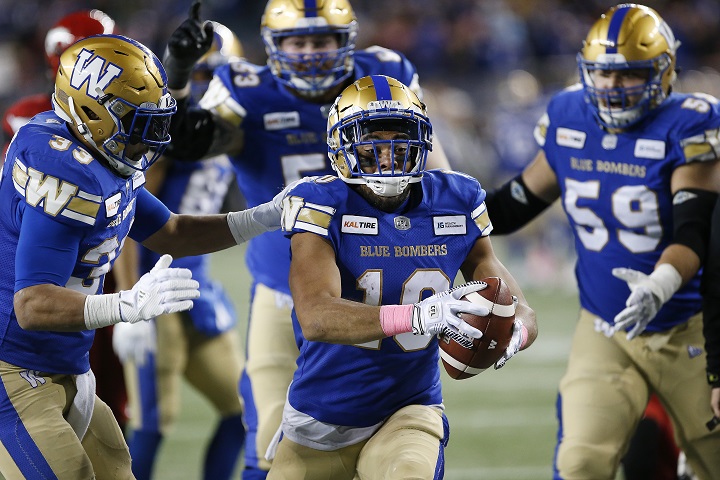 Winnipeg Blue Bombers' Darvin Adams (1) celebrates scoring the touchdown against the Calgary Stampeders during the first half of CFL action in Winnipeg Friday, October 25, 2019. 