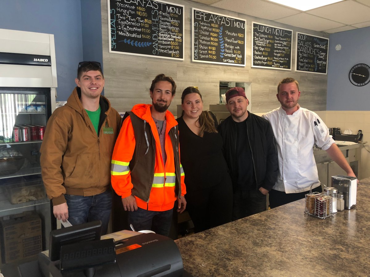Early Riser Cafe owner Brad Heslop (far right) and his friends teamed up to support community members in need by cooking a classic Thanksgiving meal and delivering it to their front doors.