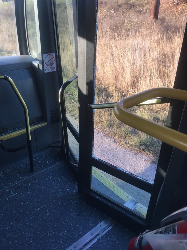 Pieces of glass from a smashed door pane litter the floor of this bus following an alleged minor incident with a semi on Tuesday morning.