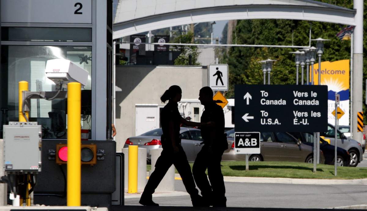 Canadian border guards are silhouetted as they replace each other at an inspection booth at the Douglas border crossing on the Canada-USA border in Surrey, B.C., on Thursday August 20, 2009. One year after pot became legal in Canada, it's still a tricky issue to cross the U.S. border where marijuana is not legal federally. 