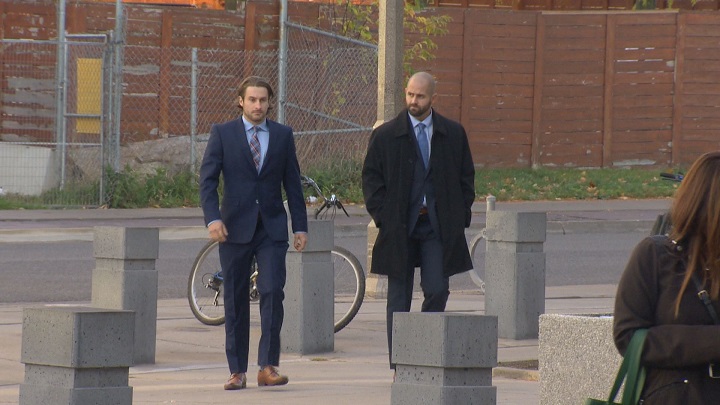 Christian Theriault and Michael Theriault, who’s also a Toronto police constable, arrive to court Tuesday for trial.