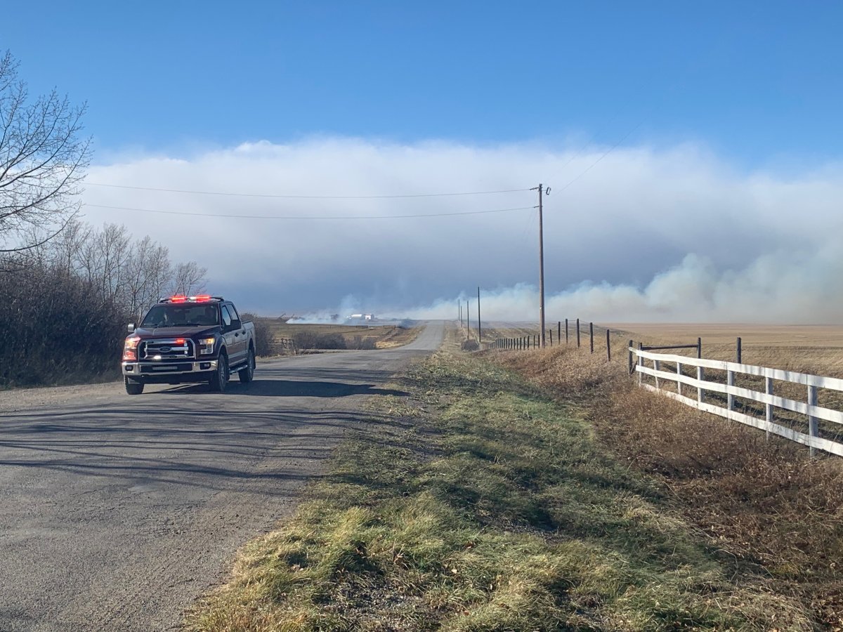 Crews battle large grass fires across southern Alberta as wind warning