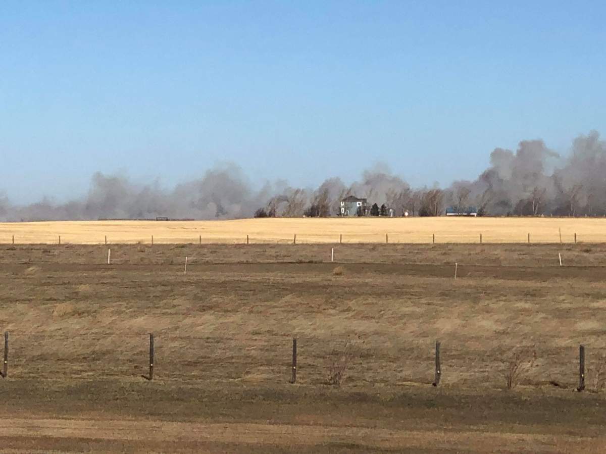 Smoke seen billowing from a grass fire in the High River area on Friday, Oct. 25.