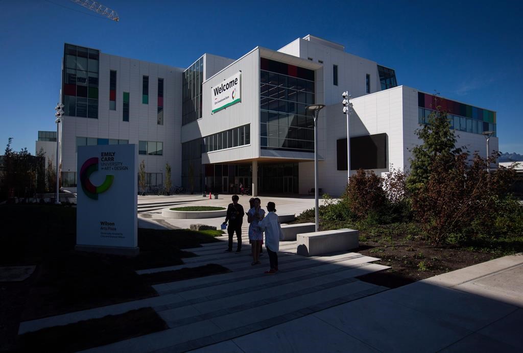 People stand outside the new Emily Carr University of Art and Design campus in Vancouver, B.C., on Friday September 1, 2017. The university campus remains closed today following a small fire Saturday morning.