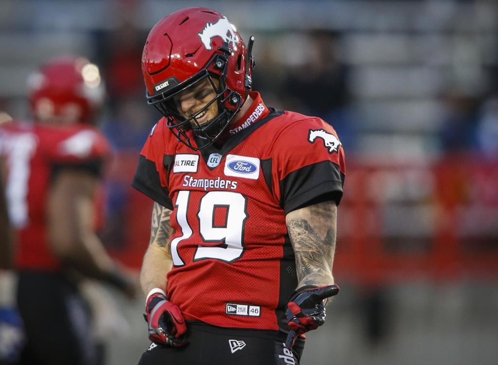 Calgary Stampeders quarterback Bo Levi Mitchell plays air-guitar as he celebrates a touchdown pass during first half CFL football action againt the Winnipeg Blue Bombers in Calgary, Saturday.
