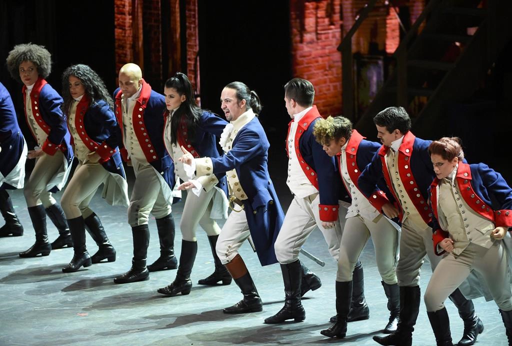 FILE - In this June 12, 2016 file photo, Lin-Manuel Miranda, center, and the cast of "Hamilton" perform at the Tony Awards in New York. Tickets for the Canadian premiere of smash musical "Hamilton" will go on sale on Oct. 28. THE CANADIAN PRESS/Evan Agostini/Invision/AP, File.