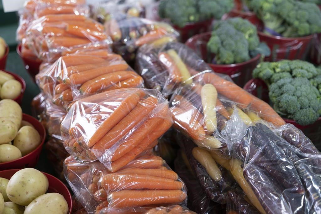 Carrots wrapped in a plastic bag are seen at a market in Montreal on Thursday, June 13, 2019.