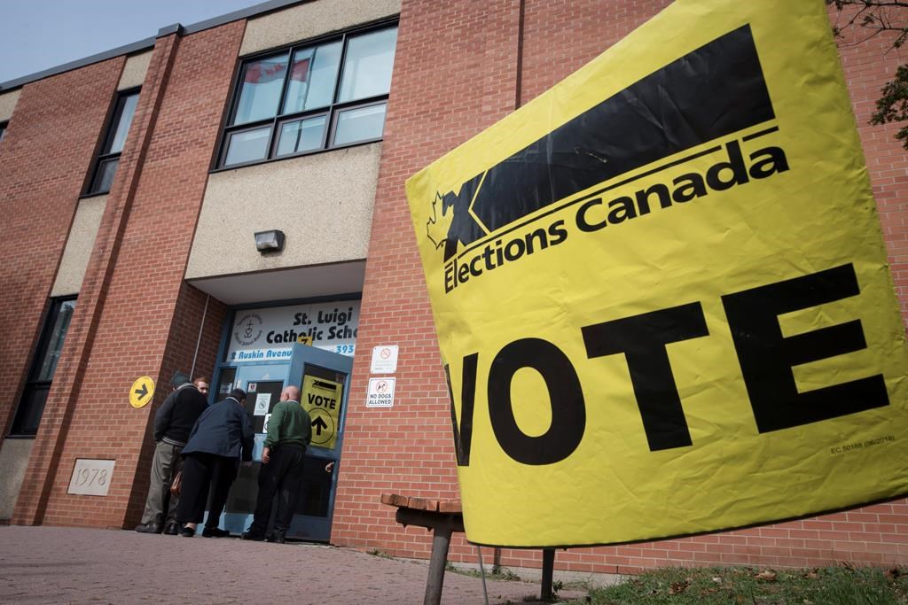 Voters enter the polling station at St. Luigi Catholic School during election day in Toronto on Monday, October 21, 2019.
