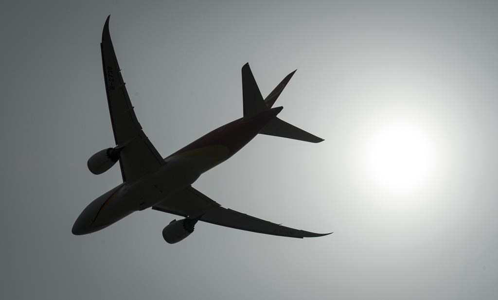 A plane is silhouetted as it takes off from Vancouver International Airport in Richmond, B.C., Monday, May 13, 2019. 