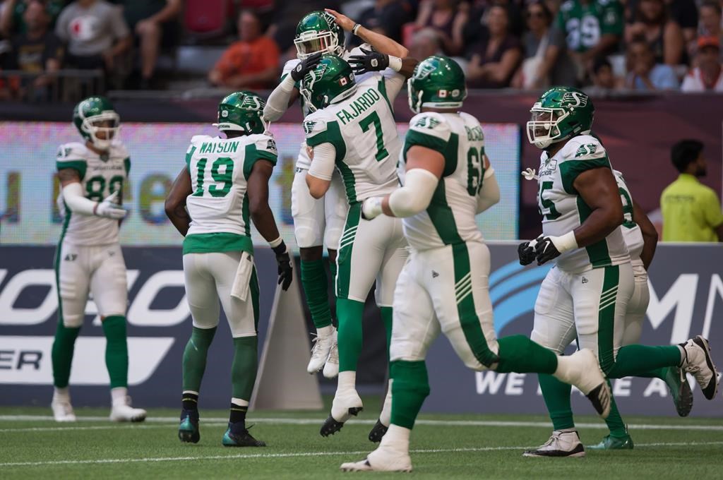 Saskatchewan Roughriders' Kyran Moore, back centre, and quarterback Cody Fajardo (7) celebrate Moore's touchdown during the first half of a CFL football game against the B.C. Lions, in Vancouver, on Saturday July 27, 2019. The Saskatchewan Roughriders are hoping they can bring the spirit of Regina with them on their final road trip of the season.