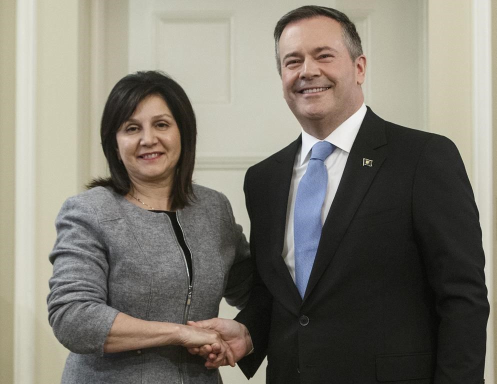 Alberta premier Jason Kenney shakes hands with Adriana LaGrange, Minister of Education after being is sworn into office, in Edmonton on Tuesday April 30, 2019.