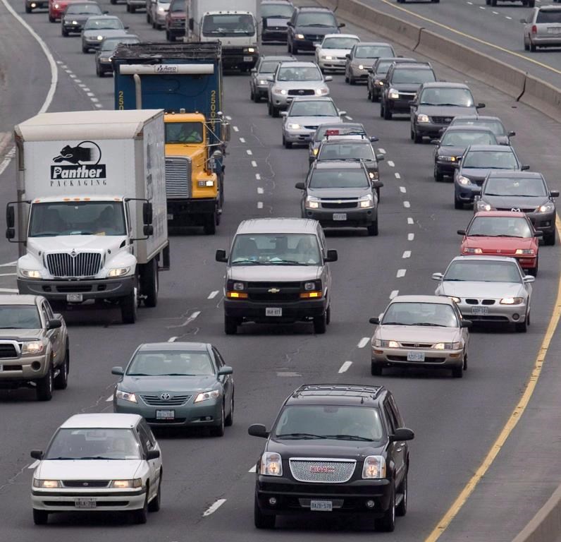 Cars makes their way along a congested highway in Toronto on April 26, 2007. 