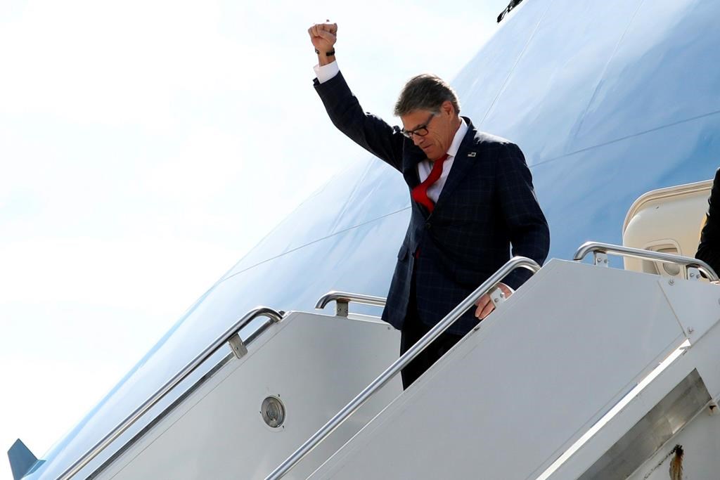 Energy Secretary Rick Perry gestures as he arrives on Air Force One with President Donald Trump at Naval Air Station Joint Reserve Base in Fort Worth, Texas, Thursday, Oct. 17, 2019.