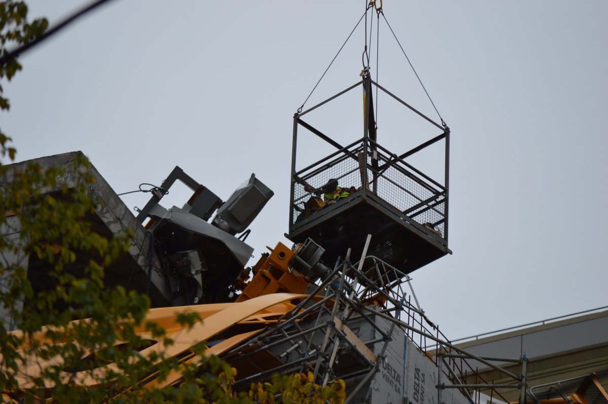 Work crews have begun dismantling pieces of the toppled crane.