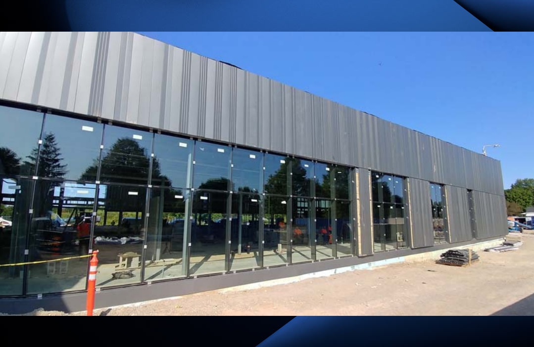 A July 2019 photograph depicts the east facade at the north entry of the East Lions Community Centre.