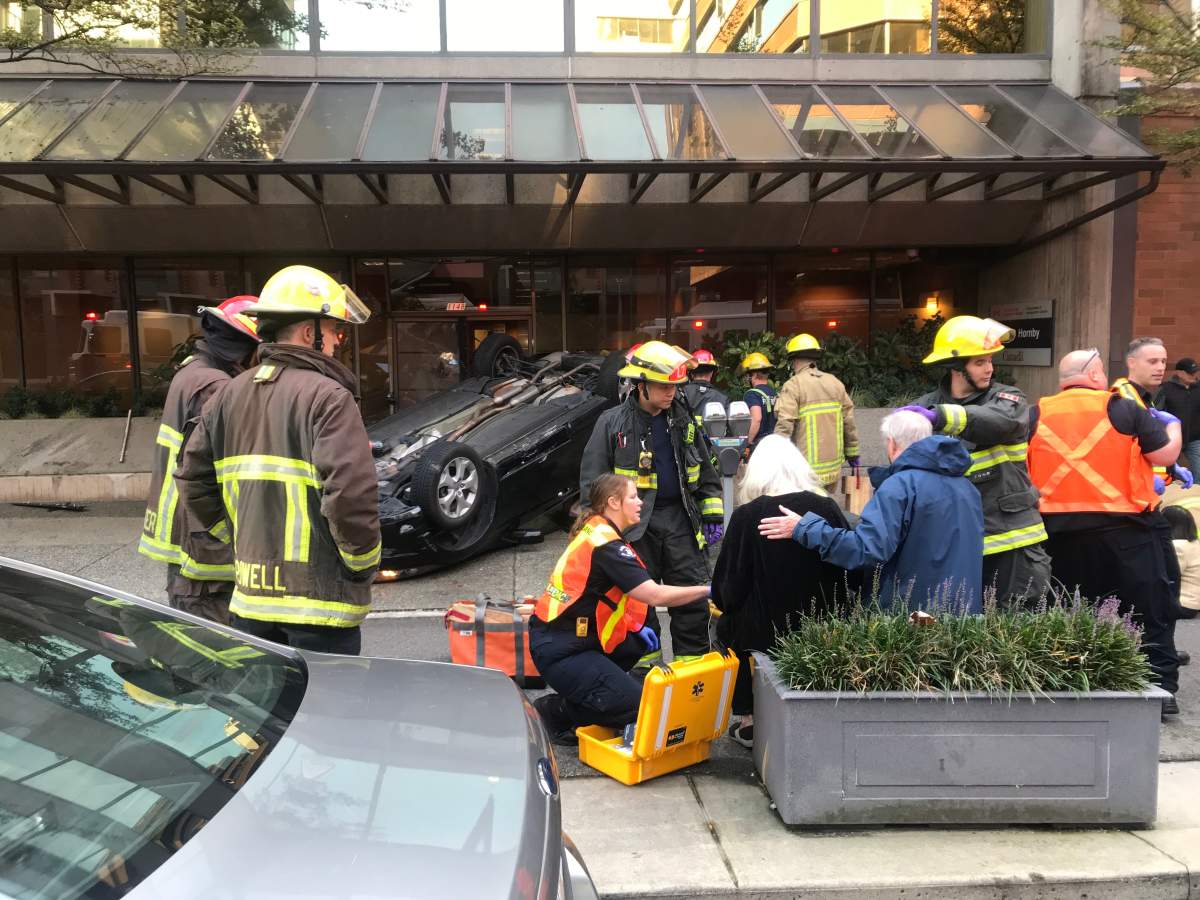 First responders attend to people injured in a single-vehicle crash in downtown Vancouver on Tuesday, Oct. 8, 2019.