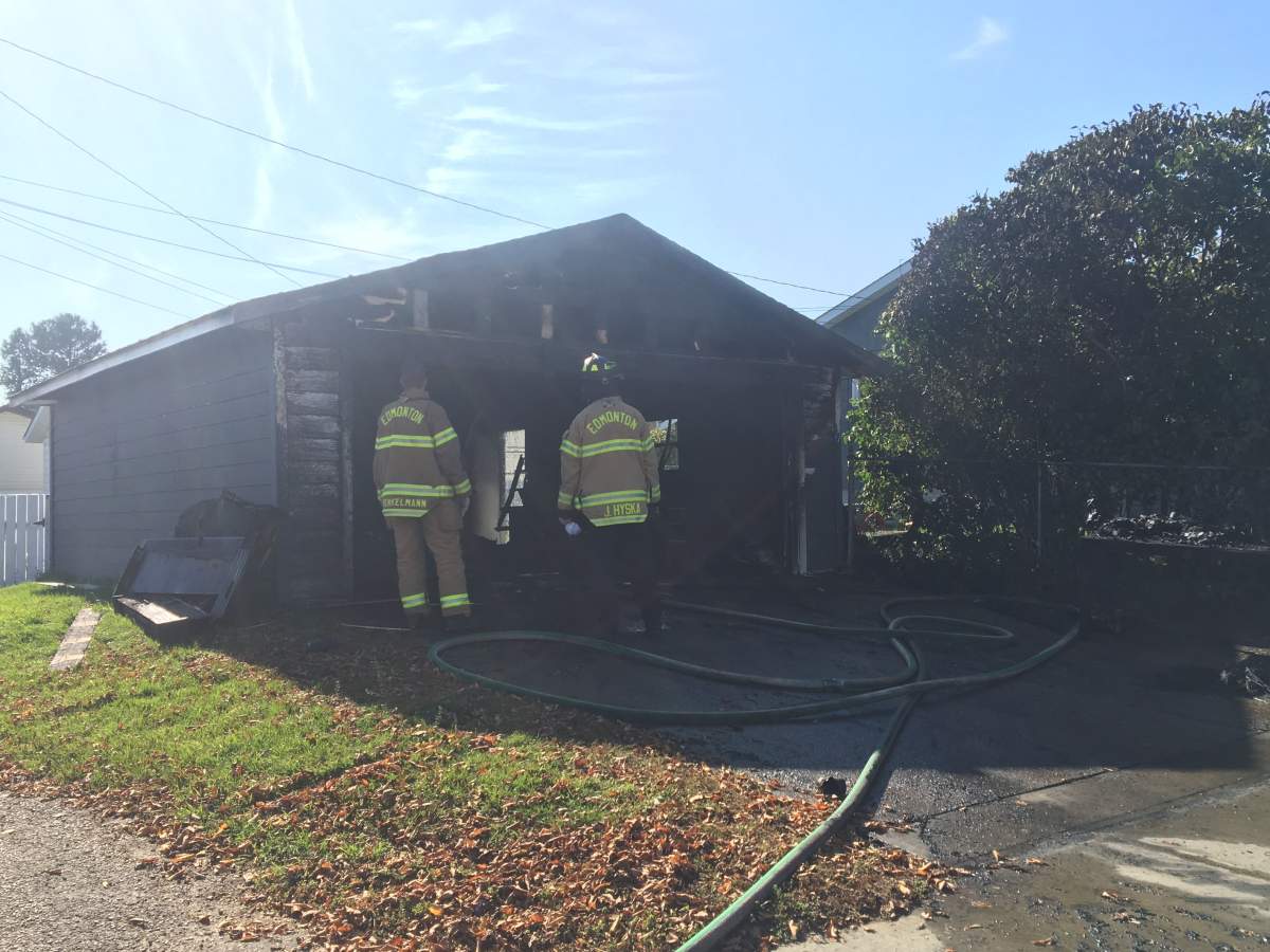 Fire crews douse a blaze at a house and garage in the area of 137 Avenue and 137 Street Tuesday, Oct. 1, 2019.
