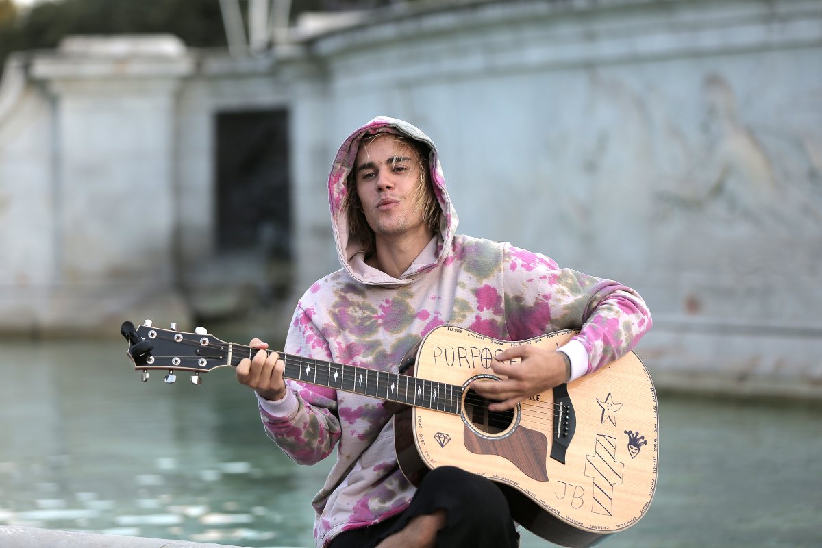 Justin Bieber stops at the Buckingham Palace fountain to play a couple of songs with his guitar for Hailey Baldwin and fans on Sept. 18, 2018 in London, England.