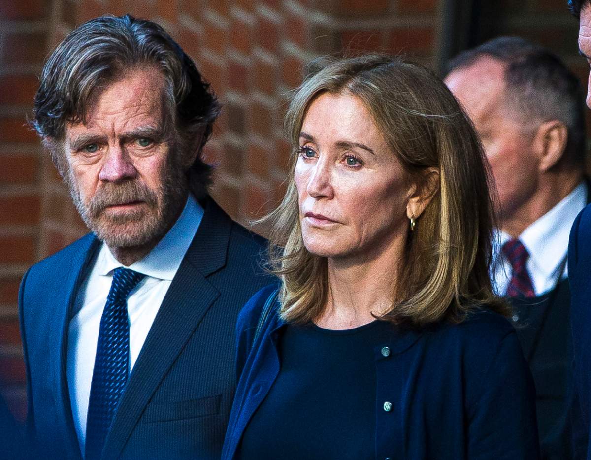 Felicity Huffman, right, and her husband, William H. Macy, walk out of the John Joseph Moakley United States Courthouse in Boston on Sep. 13, 2019. 