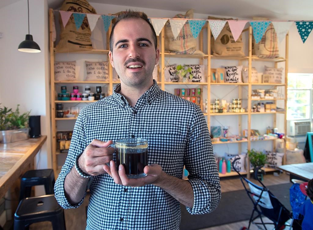 Jason Selby takes a break in his cafe in Dartmouth, N.S., on Monday, Oct. 16, 2019.