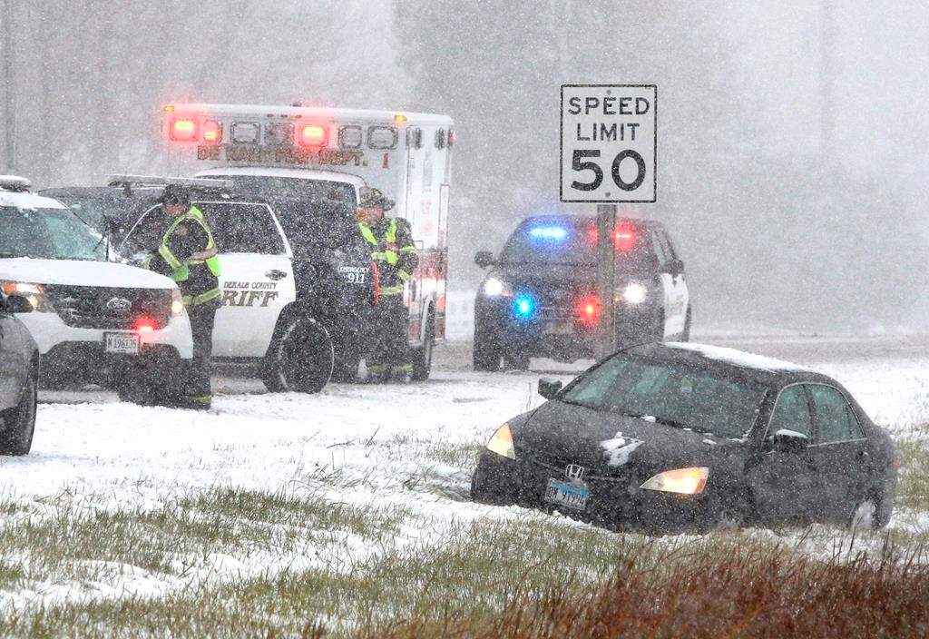DeKalb County Sheriff's deputies and DeKalb firefighters and paramedics respond to a car in the ditch on Route 23 just south of Gurler Road as snow and wind continue to make driving hazardous in DeKalb Thursday, Oct. 31, 2019. A Halloween snow storm blanketed much of the area with ice and snow Wednesday night into Thursday. (Mark Busch/Daily Chronicle via AP).