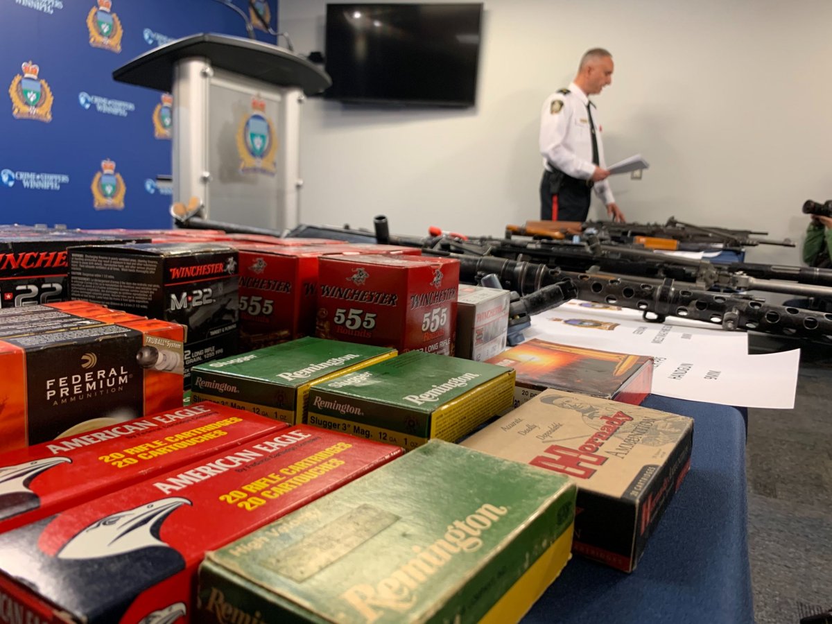 Winnipeg police display some of the seized weapons and ammunition.
