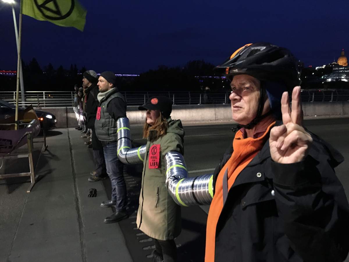 Activists with the Extinction Rebellion movement blocking the Walterdale Bridge into downtown Edmonton Monday morning as part of international protests demanding new climate policies. Monday, October 7, 2019.