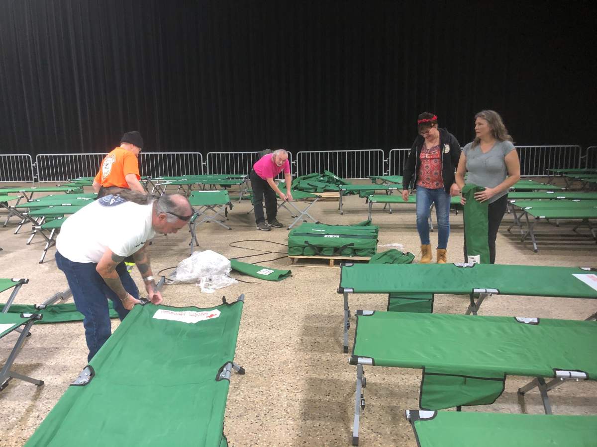 Volunteers prepare cots at the RBC Convention Centre, the site of a warming shelter for First Nations communities without power.