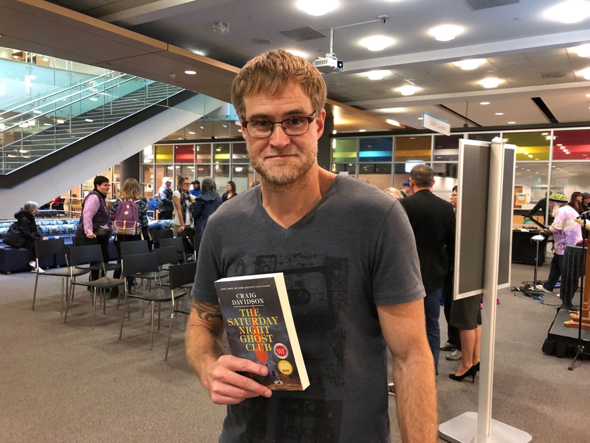 Author Craig Davidson holds up a copy of The Saturday Night Ghost Club. The novel has been chosen for the annual One Book One London initiative. 