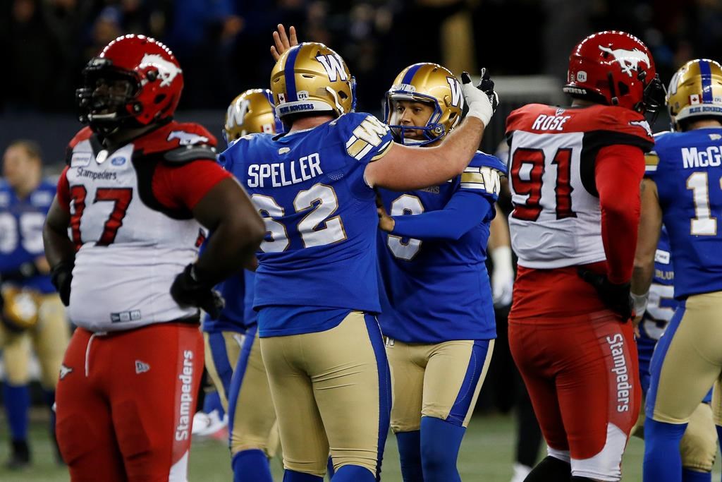 Winnipeg Blue Bombers' Justin Medlock (9) celebrates kicking the winning field goal against the Calgary Stampeders with Cody Speller (62) during the second half of CFL action in Winnipeg Friday, October 25, 2019. THE CANADIAN PRESS/John Woods.