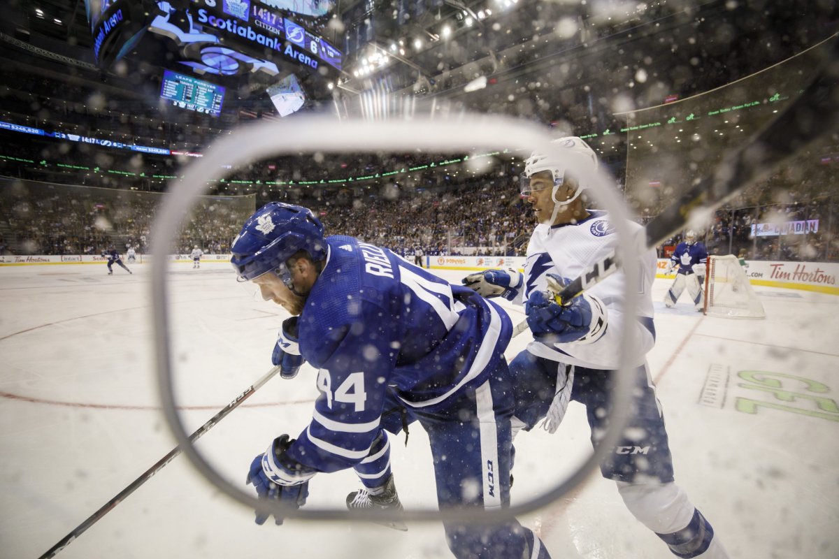 Toronto Maple Leafs defenceman Morgan Rielly (44) and Tampa Bay Lightning right wing Mathieu Joseph (7) battle for the puck during the third period of their game in Toronto, Thursday, Oct. 10, 2019.