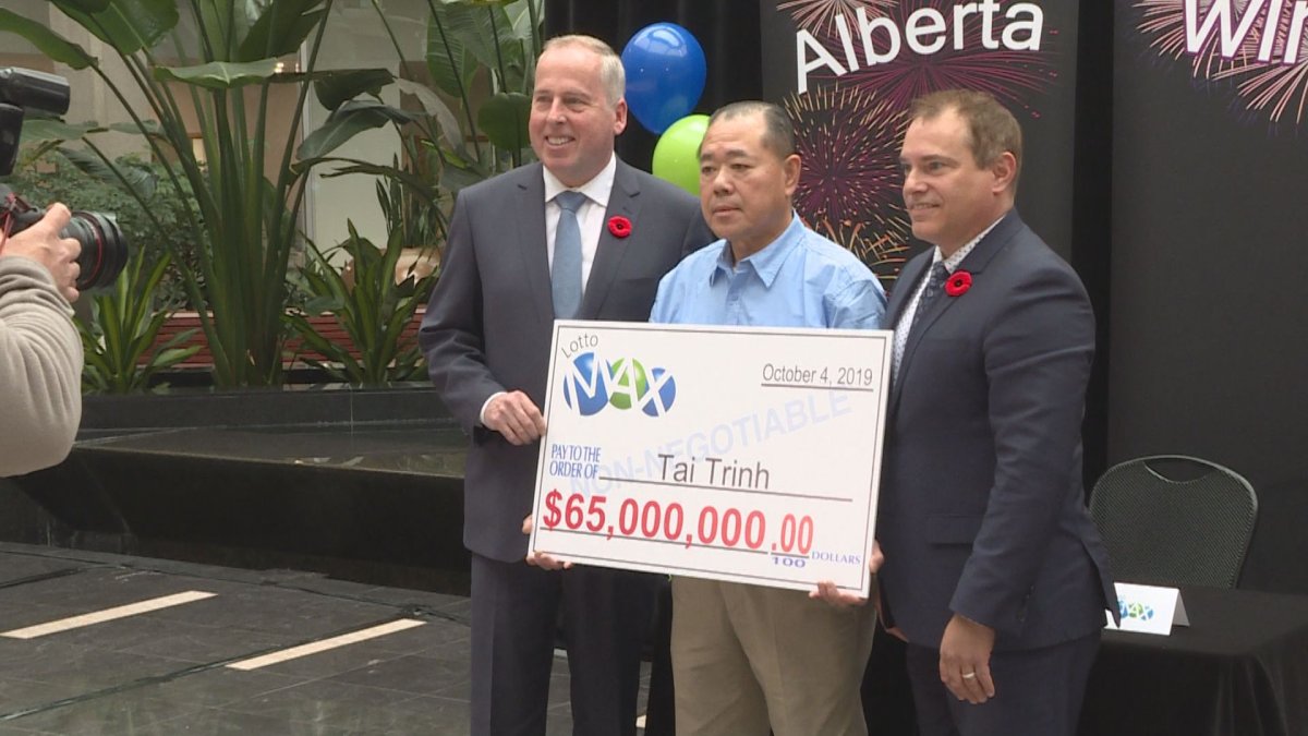 A Calgary man holds his new found winnings on Thursday after being named the official winner of Octobers LottoMAX jackpot. 