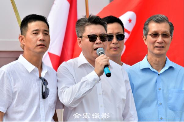 Michael Chan and Weng Guoning, chairman of the Toronto Confederation of Chinese Canadian Organizations, are among those shown in a photo from the August rally.