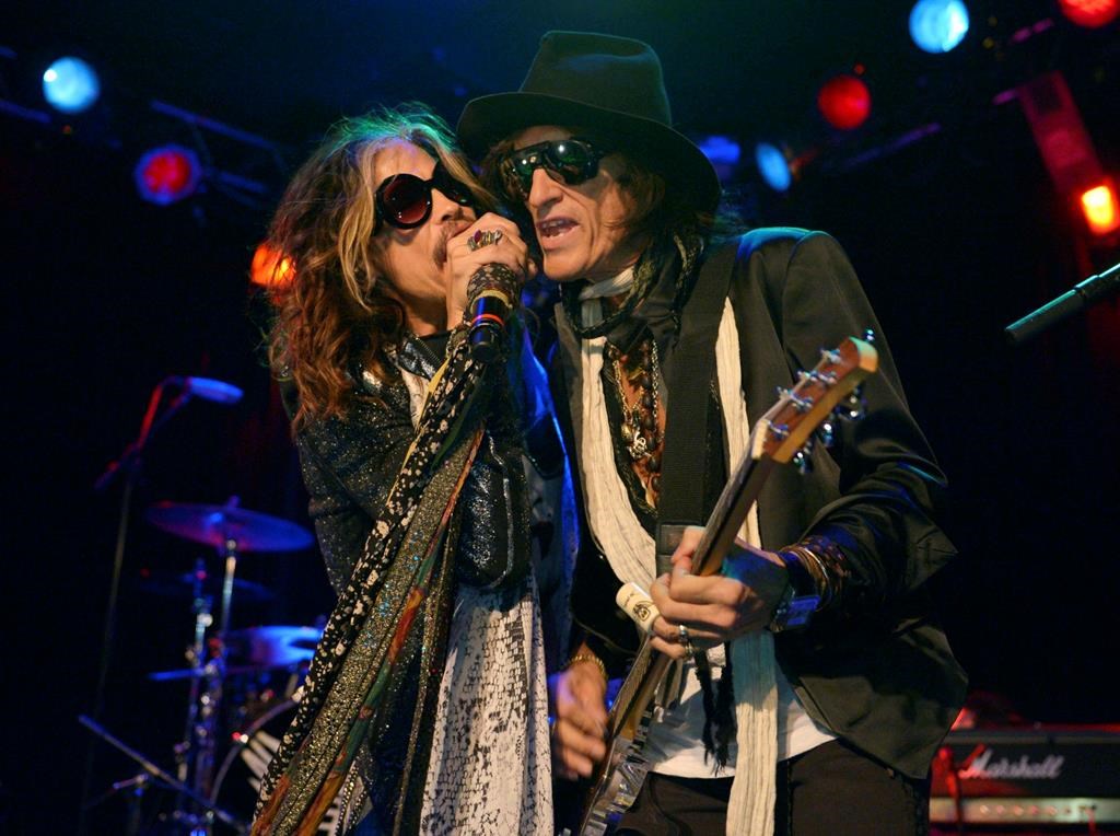 In this April 8, 2014, file photo, Steven Tyler, left, and Joe Perry of Aerosmith perform at the Whisky A Go Go in Los Angeles, Calif.