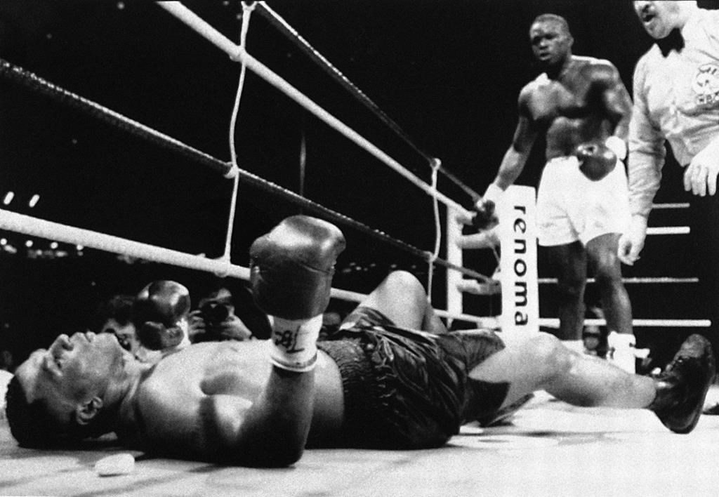 In this Feb. 11, 1990, file photo, champion Mike Tyson lies flat on his back after being decked by challenger James “Buster” Douglas.