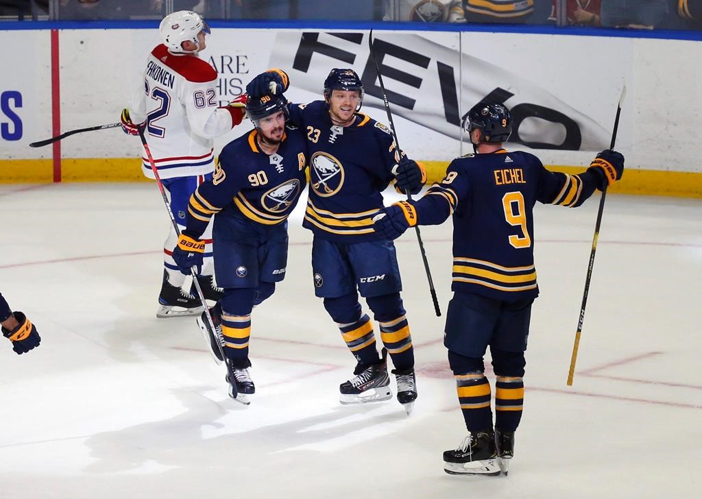 Buffalo Sabres forwards Marcus Johansson (90), Sam Reinhart (23) and Jack Eichel (9) celebrate a goal by Johansson during overtime in the team's NHL game against the Montreal Canadiens, Wednesday, Oct. 9, 2019, in Buffalo, N.Y.